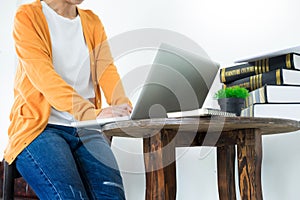 Attractive Young beautiful entrepreneur Woman smiling and looking at laptop screen, Working from Home.