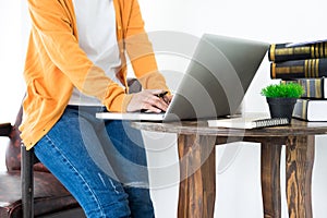 Attractive Young beautiful entrepreneur Woman smiling and looking at laptop screen, Working from Home