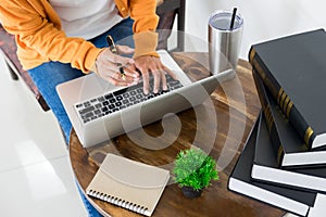 Attractive Young beautiful entrepreneur Woman smiling and looking at laptop screen, Working from Home