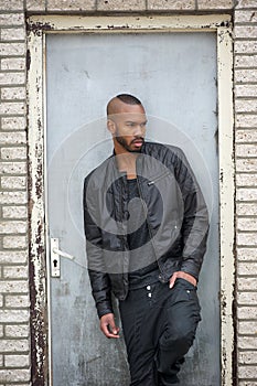 Attractive young black man standing in door way