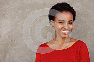 Attractive young black woman in red shirt smiling