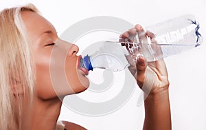 Attractive young blond girl drinking water