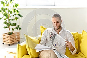 Attractive young blonde haired man wearing white shirt