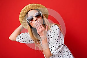 Attractive young blonde woman wearing everyday stylish clothes and modern sunglasses isolated on colorful background