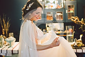 Attractive young bride before wedding ceremony. Bride`s Preparations. Wedding Morning. Charming bride in white wedding dress at