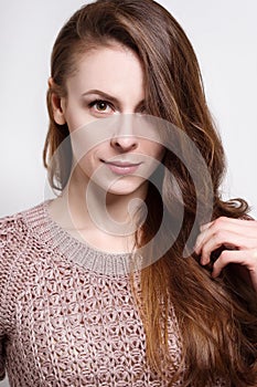 Attractive young brunette woman in a cozy sweater