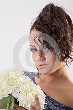Attractive young brunette woman holding fresh flowers