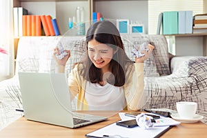 Attractive young business asian woman holding, clutching crumpled paper. Young university student get angry and grimace face