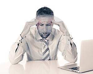 Attractive young business man with headache working on computer stressed tired and overwhelmed