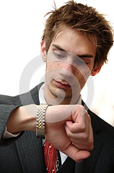 Attractive Young businessman checks time