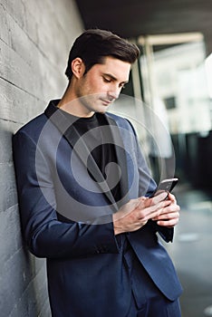 Attractive young businessman on the phone in an office building