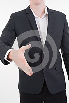 Attractive young businessman standing and giving his hand for ha