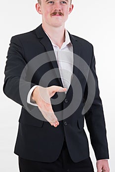 Attractive young businessman standing and giving his hand for ha