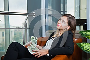 Attractive young businesswoman counting money dollars and smile