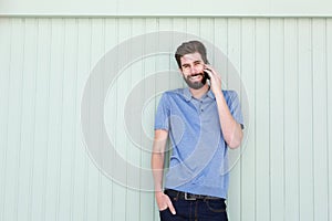 Attractive young casual man talking on mobile phone