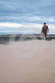 Attractive young caucasian wanderer walking in the desert.