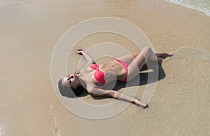 Attractive Young Caucasian Woman In Swimsuit Lying On Beach Top View, Girl Wet Sand Sea Ocean Holiday