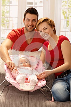 Attractive young couple with baby girl