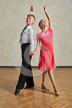 Attractive young couple of children dancing ballroom dance