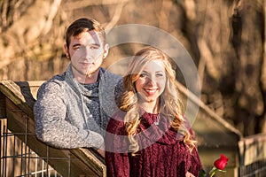 Attractive young couple facing the viewer posing for portrait