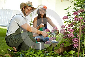 Attractive young couple gardening together