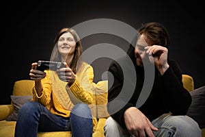 Attractive young couple having fun playing video games console joysticks