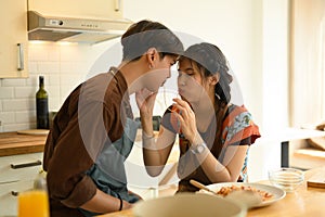 Attractive young couple having romantic lunch together in kitchen