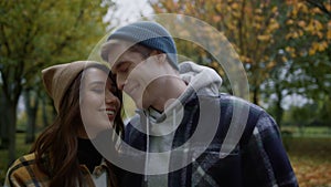 Attractive young couple lucky being together outdoors in autumn weather.