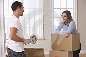 Attractive Young Couple Packing And Smiling