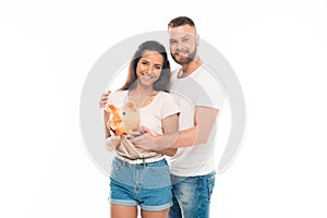 attractive young couple with piggy bank,