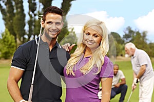 Attractive young couple ready for golfing