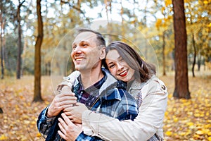 Attractive young couple spending time together in autumn park. Family Concept. Happy Couple.