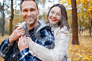 Attractive young couple spending time together in autumn park. Family Concept. Happy Couple.