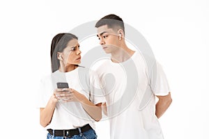 Attractive young couple standing isolated over white