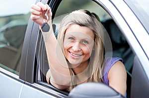 Attractive young driver holding a key