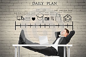 Attractive young european businessman relaxing at desk with abstract daily planner scale on white brick wall background. Organizer