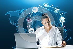 Attractive young european businesswoman doing paperwork at desk with creative global map hologram with 24 7 online support on blue