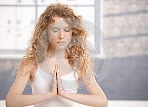 Attractive young female doing yoga exercise