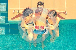 Attractive young friends having fun in a swimming pool