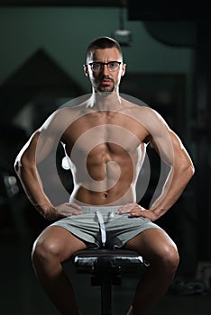 Attractive Young Geek Resting In Gym Afther Exercise