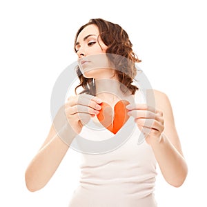 Attractive young girl holding broken paper red valentine heart