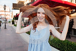 Attractive young girl playing with her hair