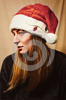 Attractive young girl with red santa hat posing