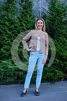 Attractive young girl smiling and posing to camera and stands in