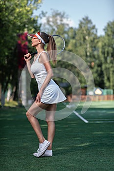 Attractive young girl with a tennis racket