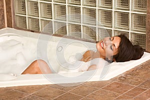 Attractive young gorges woman taking bubble bath