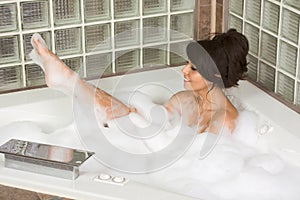 Attractive young gorges woman taking Bubble bath