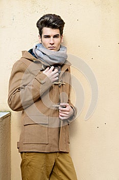 Attractive young handsome man, model of fashion in urban background