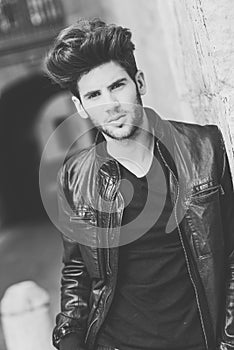 Attractive young handsome man, model of fashion in urban background