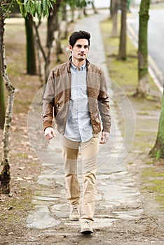 Attractive young handsome man, model of fashion in urban background